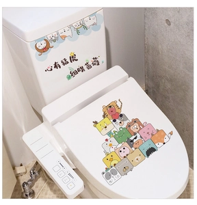 Close-up of PVC waterproof cartoon animal stickers and Chinese text on a white toilet tank