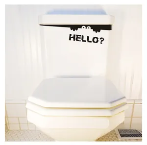 Close-up of waterproof black vinyl toilet sticker with funny peeking eyes and Hello text