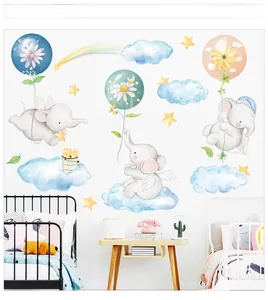 Detail of cartoon elephant and rainbow wall stickers in a cozy nursery room setting