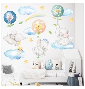 Detail view of cartoon elephant wall stickers set in a cozy nursery room setting