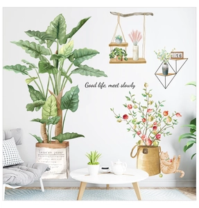 Detail of self-adhesive wall stickers with green plants, cat and artistic lettering