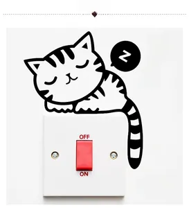 Close-up of sleeping cat wall sticker with 'Z' bubbles on a white power switch