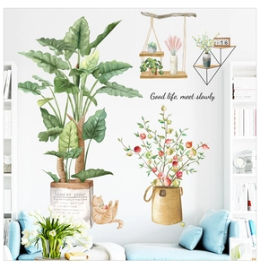 Detail of tropical green plant wall decals with artistic lettering on white wall