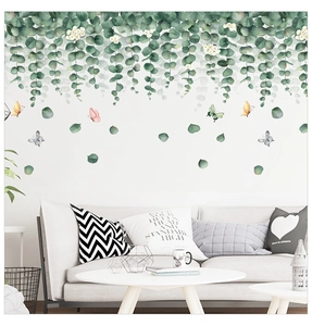 Modern wall sticker featuring eucalyptus leaves and colorful butterflies in a living room decor
