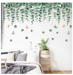 Detail of eucalyptus wall stickers with white flowers and butterflies in a bedroom