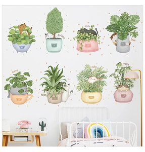 Close-up of waterproof PVC wall stickers featuring cute cats and potted green plants