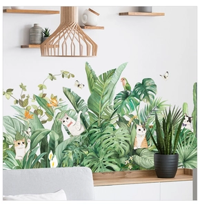 Close-up of tropical leaf wall decals with cats and birds for a fresh home interior