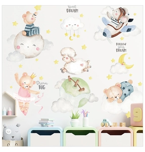 Detail of cartoon bear and sheep wall stickers with moon and stars for nursery decor