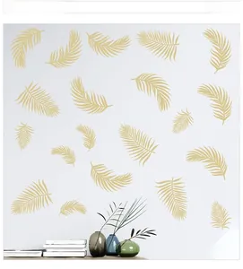 Detailed view of champagne gold palm leaf wall decals in a modern living room setup