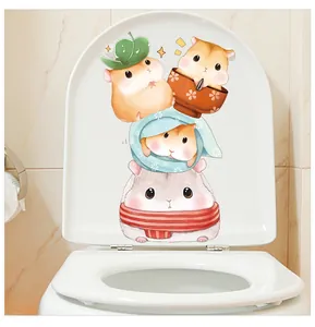 Close-up of cute cartoon hamster stickers on a white toilet lid for bathroom decor