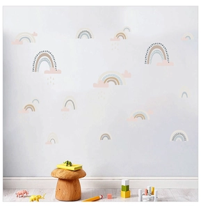 Detailed view of Nordic rainbow and cloud wall stickers in a cozy nursery bedroom setting