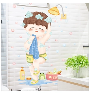 Detailed view of a cartoon boy shower wall sticker on white bathroom tiles