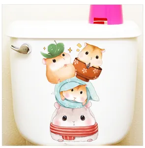 Detail of cute cartoon hamster stickers applied to a white ceramic toilet tank surface