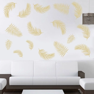 Golden palm leaf wall stickers for modern living room decor on a white wall above a sofa