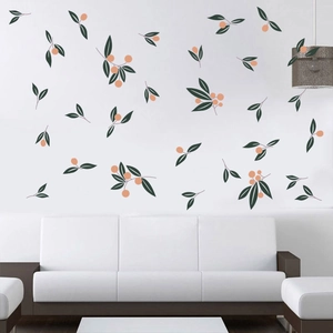 Minimalist green leaf and orange berry wall stickers in a modern white living room