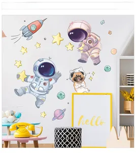 Detailed view of cartoon astronaut, space dog, and rocket wall stickers in kids' bedroom decor