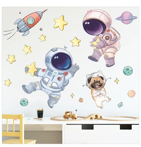Detailed view of astronaut and rocket wall stickers in a cozy kids' bedroom setting