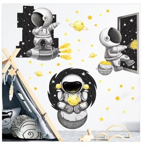 Cartoon astronaut wall stickers with planets and stars in a cozy nursery playroom decor