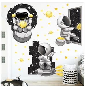 Detail of cartoon astronaut wall stickers featuring a spaceship and yellow stars for decor