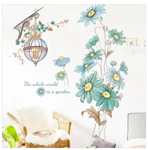 Detail view of sunflower wall decals with vintage street lamp and garden quote on white wall