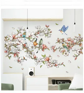 Detailed view of magnolia flower wall stickers with colorful birds in a living room