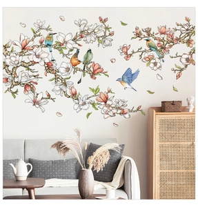 Detailed view of elegant white magnolia flower wall stickers with colorful birds in a living room