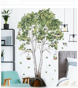 Detail of green birch tree wall decal with hanging terrariums and birds decoration