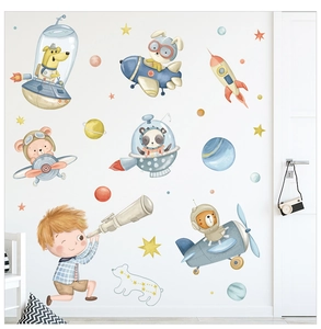 Detail showing space animal wall stickers with cartoon rockets and stars for nursery