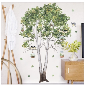 Detail of forest style birch tree wall decal with green leaves and decorative birds