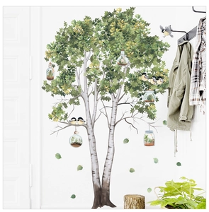 Detail of birch tree wall decal with flying birds and hanging succulent micro-landscapes