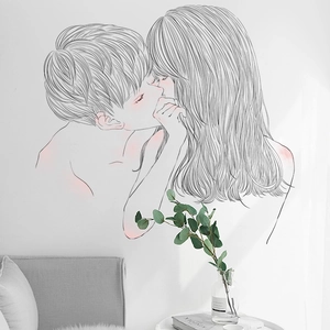 Minimalist wall sticker with romantic couple kiss line art and pink accents on white wall