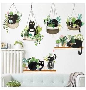 Detail of cute black cat and hanging plant wall stickers on a cozy living room wall