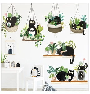 Close-up of cute black cat wall stickers with hanging plants in a cozy bedroom scene