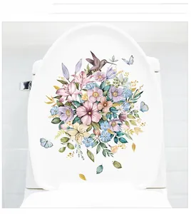 Floral watercolor stickers with blue butterflies and hummingbird on a white toilet lid