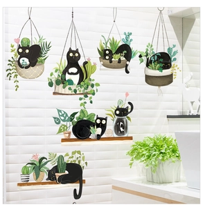 Detail of waterproof wall stickers featuring cute black cats and green hanging plants
