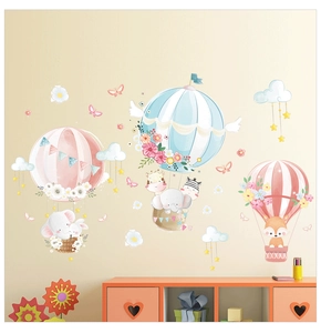 Detail of watercolor hot air balloon wall decals featuring elephant and fox for nursery