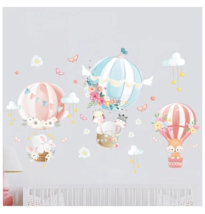 Detail of cute animal hot air balloon wall decals in a cozy nursery room setting