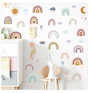 Boho rainbow and weather wall stickers on a white wall in a cozy nursery setting