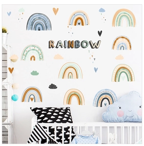 Bohemian rainbow and cloud wall stickers set displayed in a cozy Nordic nursery setting