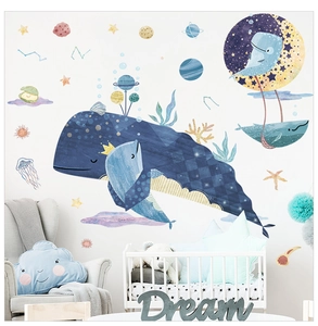Nursery wall stickers showing whale and star patterns in a cozy bedroom setting
