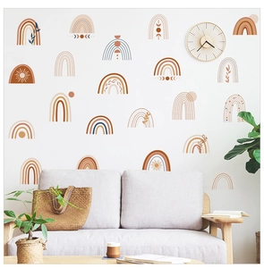 Boho rainbow wall stickers in earthy tones decorating a nursery with modern furniture