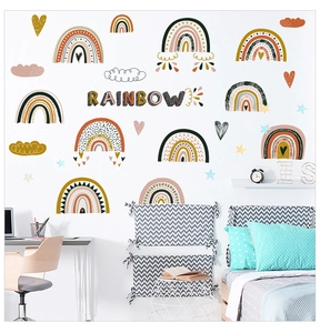 Detail of boho rainbow wall stickers with clouds and stars in a cozy kids bedroom