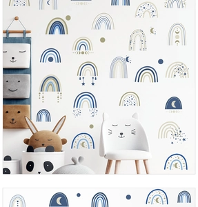 Detail of boho rainbow wall stickers in muted tones for a minimalist nursery design