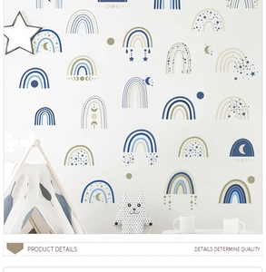 Nursery wall decals featuring clouds and rainbows displayed above a kid's play tent