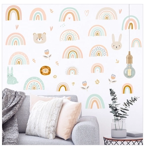 Detailed view of bohemian rainbow and animal wall decals in a warm nursery room setting