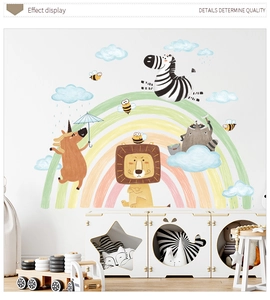 Detail showing cartoon lion zebra and rainbow wall stickers in a cozy nursery room