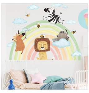 Detail view of cartoon animal wall decals featuring rainbows and lions in a kids bedroom