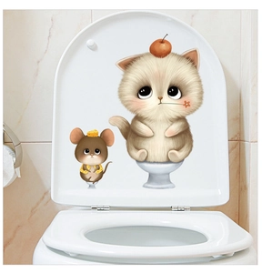 Macro detail of cartoon cat and mouse stickers applied on a white toilet lid cover
