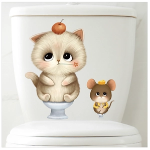 Detail showing cute cat and mouse stickers on a white toilet tank for bathroom decor