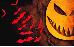 Detail of red bat wall stickers and yellow pumpkin face on dark textured background